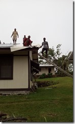 Chapel crew putting canvas over  damaged roof